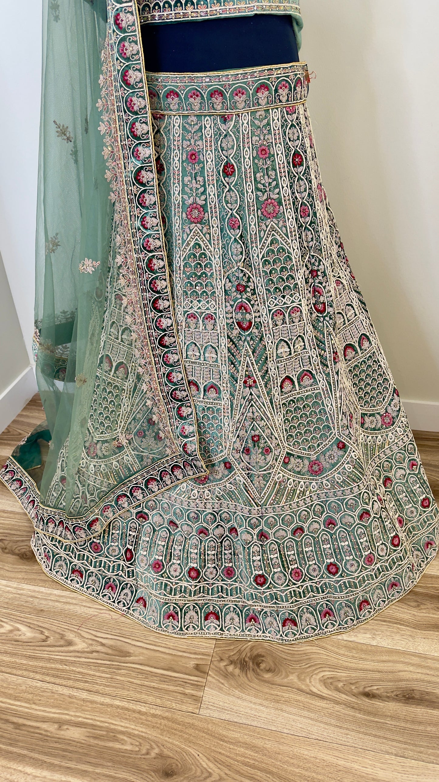 Traditional embroidered lehenga on a wooden floor