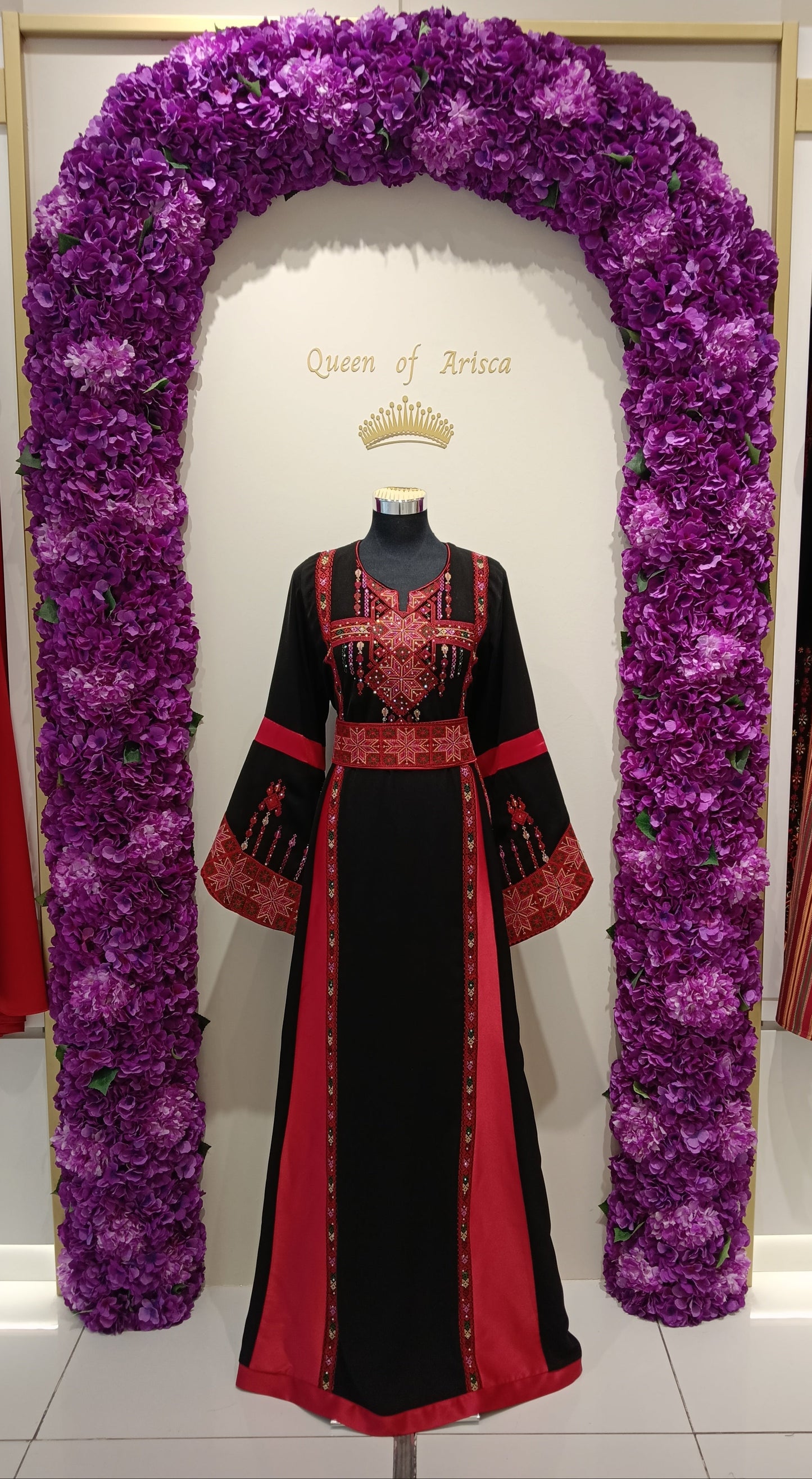 rich black base beautifully contrasted with vibrant red embroidered Palestinian motifs inspired by traditional heritage patterns