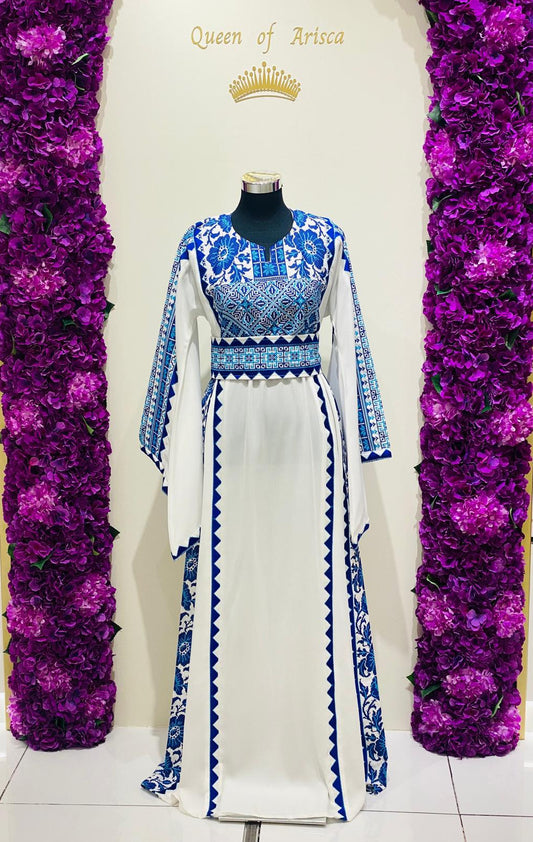 White Palestinian-inspired thobe with royal blue geometric detailing at Arisca Qatar.