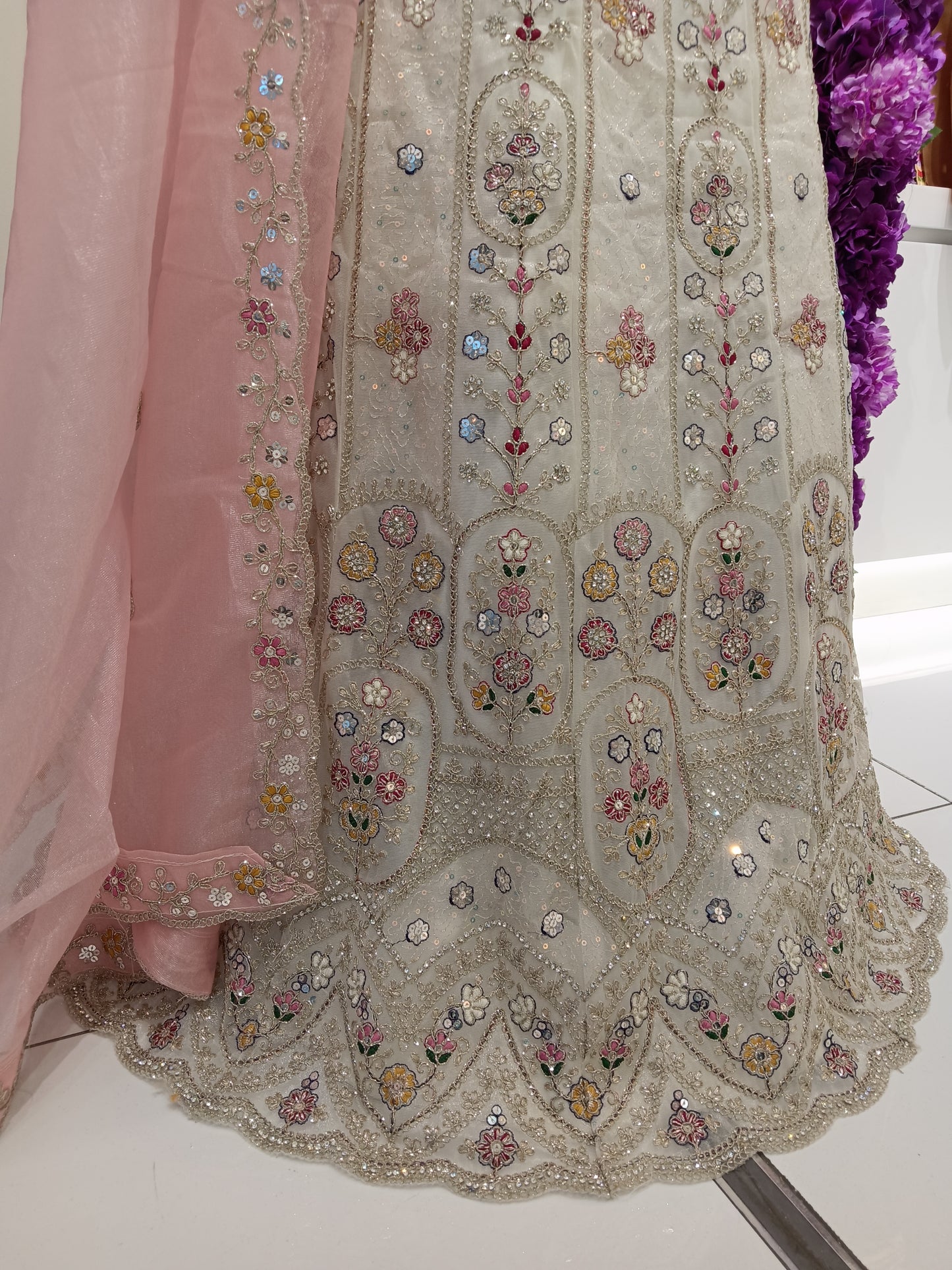 Lehenga Skirt: Premium embroidered net with soft inner lining 

Floral threadwork, sequins, zari embroidery, handcrafted embellishments Color: Pearl Ivory , Soft Blush Pink , Champagne Gold Embroidery