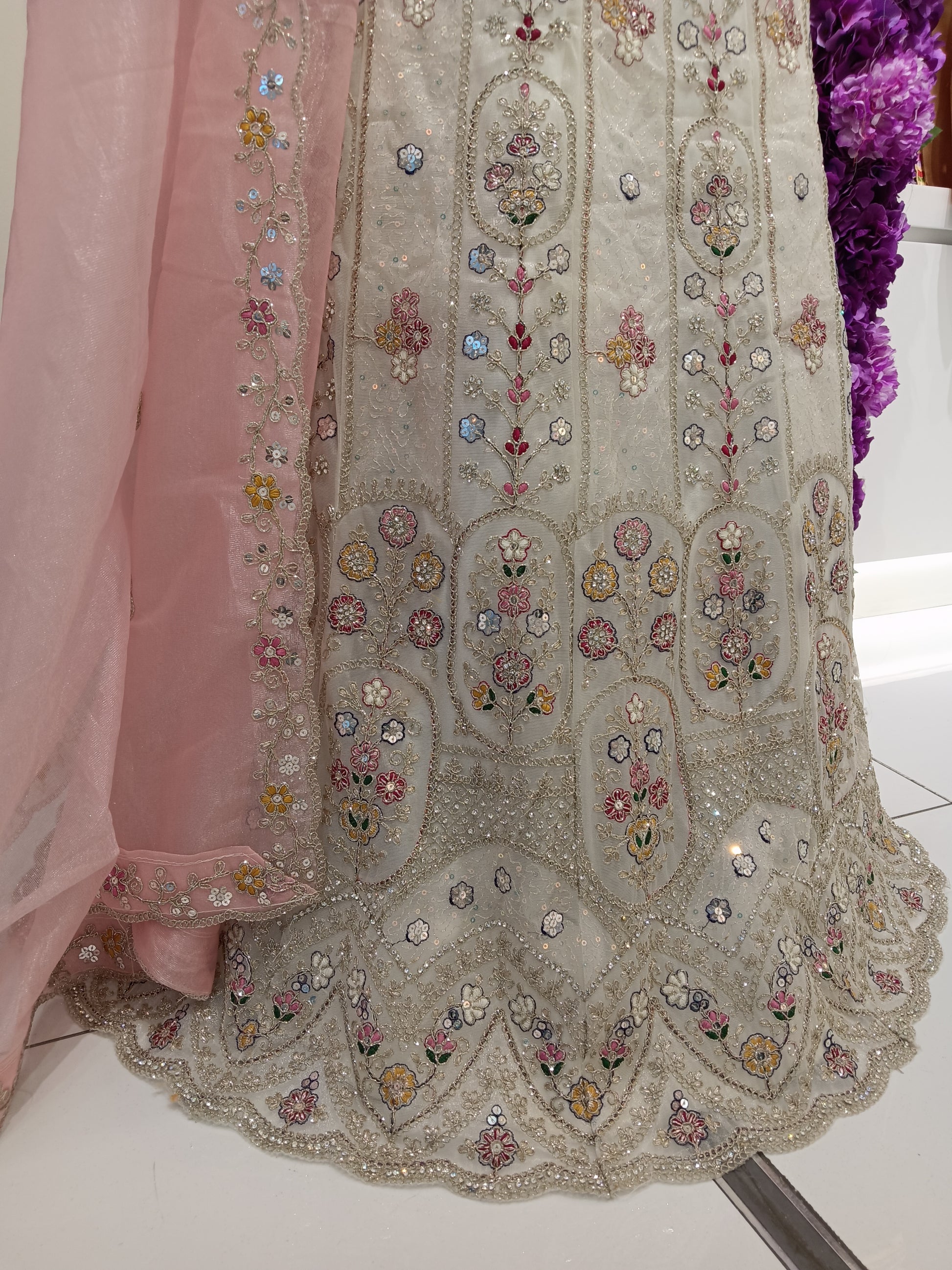Lehenga Skirt: Premium embroidered net with soft inner lining 

Floral threadwork, sequins, zari embroidery, handcrafted embellishments Color: Pearl Ivory , Soft Blush Pink , Champagne Gold Embroidery