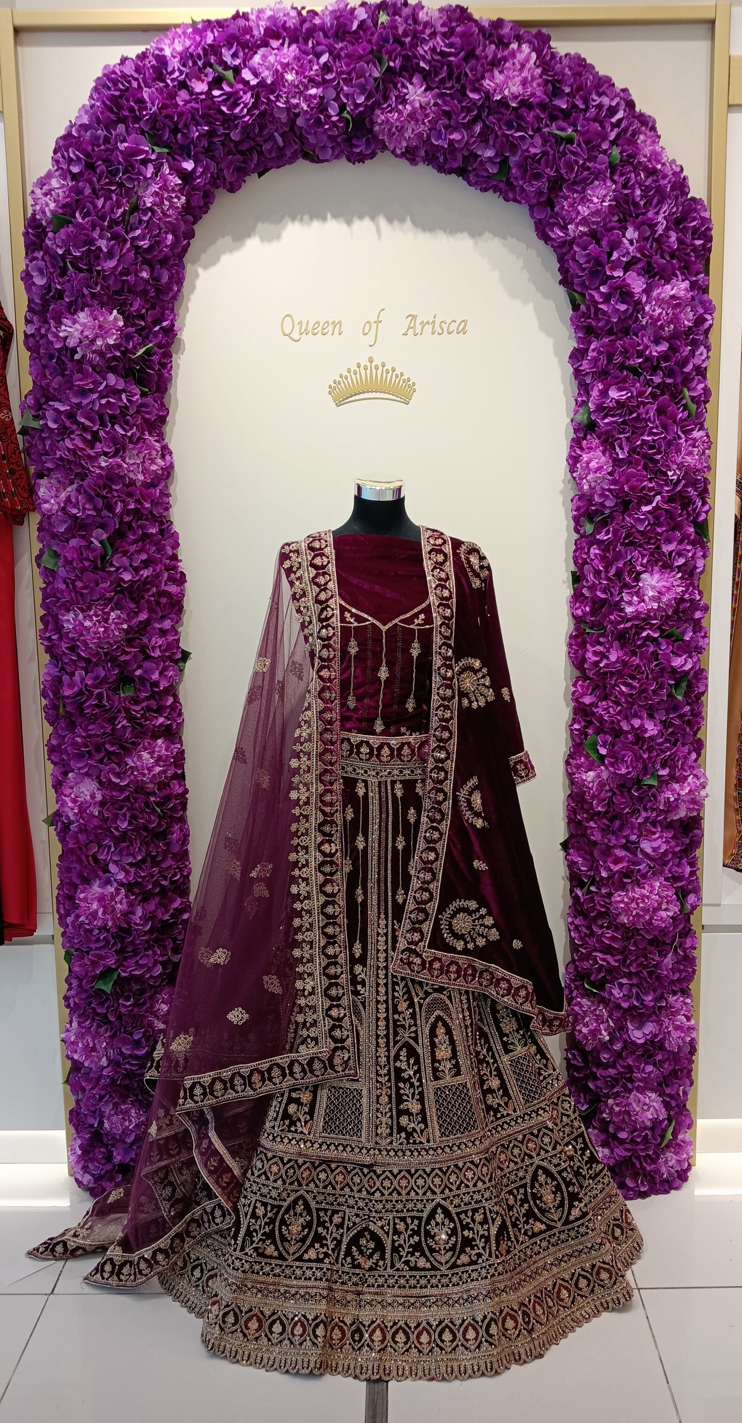 luxury maroon velvet bridal lehenga in Qatar. Heavy gold embroidery, dual dupatta.