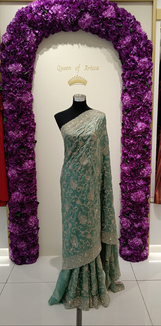 elegant ready-to-wear pre-stitched saree is crafted from a soft net/tulle fabric beautifully adorned with intricate silver zari embroidery, sequins, and bead embellishments throughout.