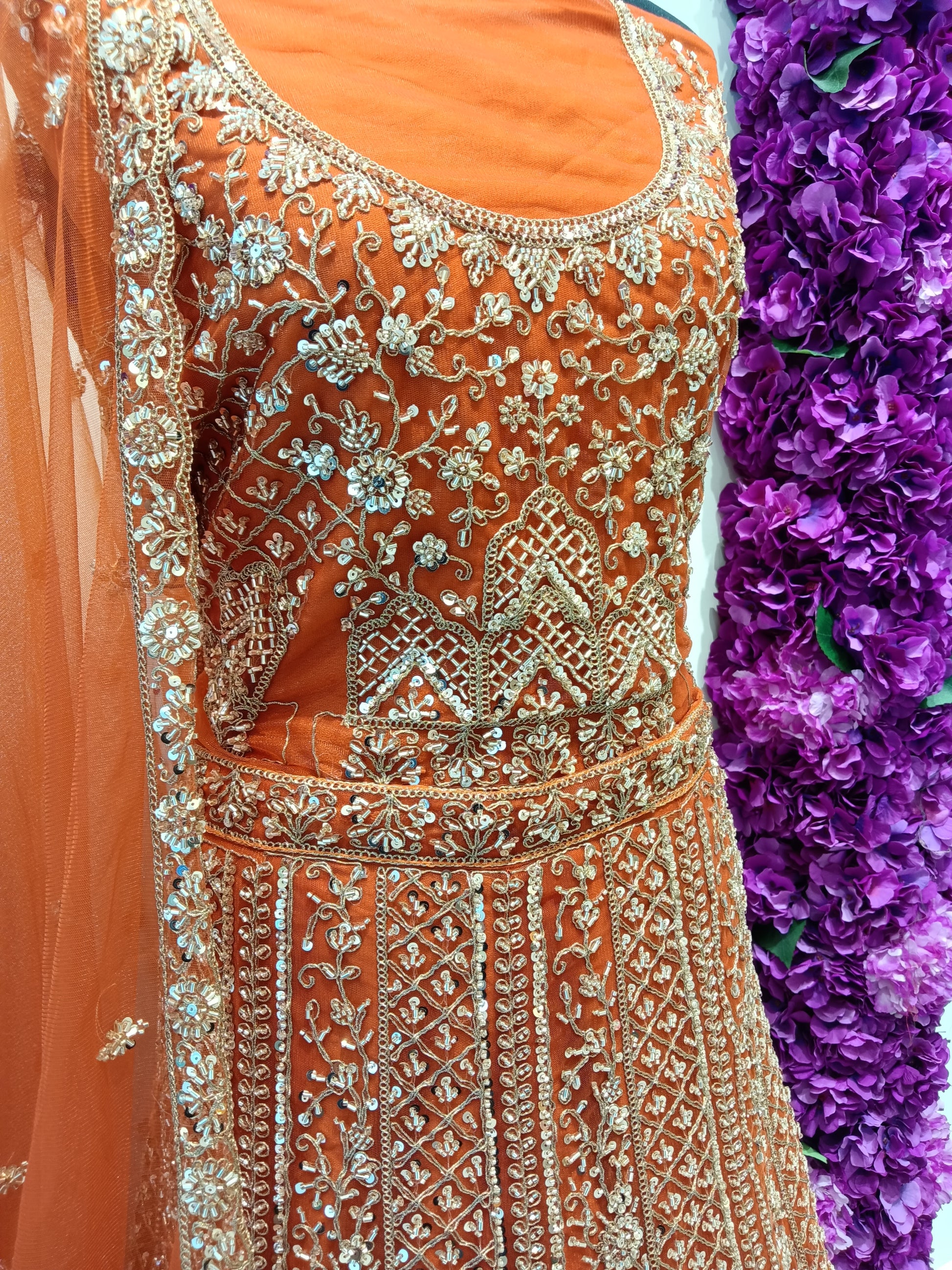Orange embroidered lehenga , dense silver & gold zari work, premium net,with gold detailing.