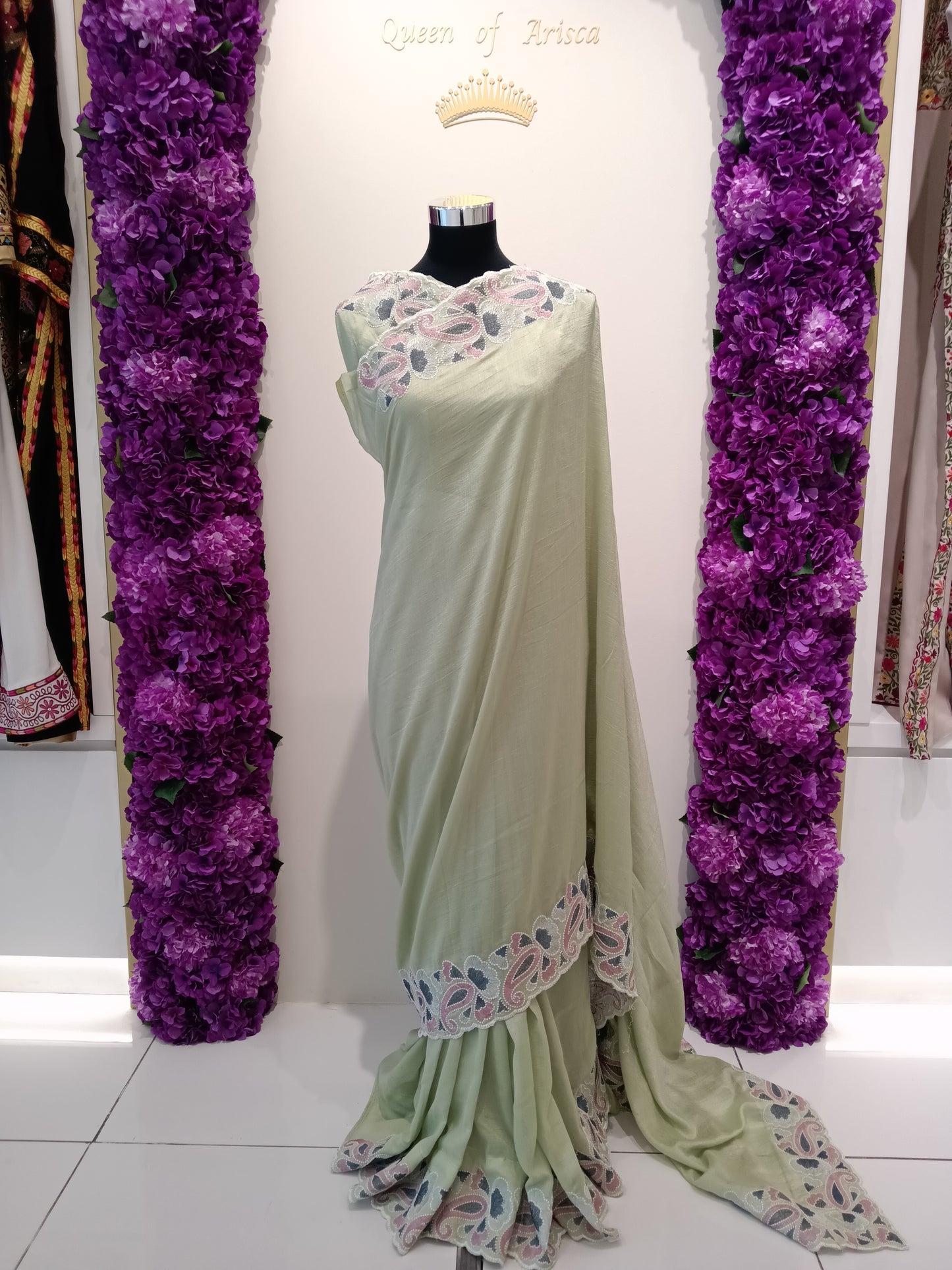 Shop mint pistachio green ready to wear saree in Qatar. Pre stitched with perfect pleats, soft flowy fabric and elegant embroidered border. Ideal for gatherings & Eid.