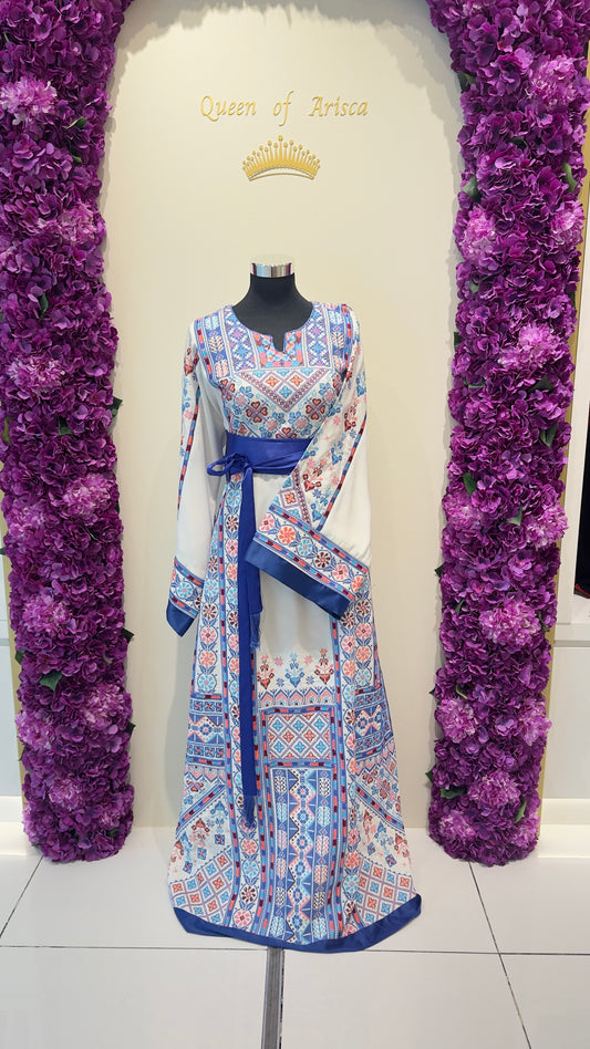 Mannequin wearing a Palestinian tatreez dress with a decorative background of purple flowers and 'Queen of Arisca' text.